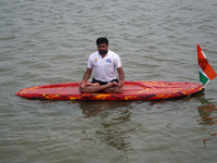 A participant performs yoga on the surface Yamuna River to mark the International Yoga Day celebrations on June 21, 2023 in New Delhi, India...