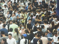  Students and their parents learn about enrollment information at the Zhejiang 2023 College Enrollment Public Consultation in Hangzhou, East...