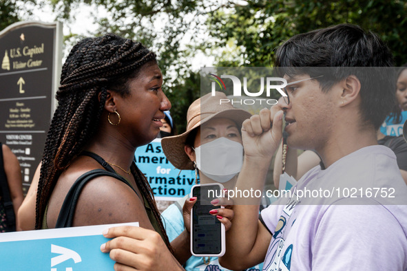 Nahla Owens, a rising junior at Harvard, and Kashish Bastola, a rising sophomore, also at Harvard, share a hug in solidarity as the protest...