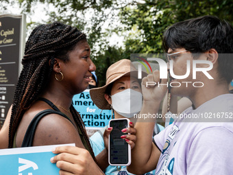 Nahla Owens, a rising junior at Harvard, and Kashish Bastola, a rising sophomore, also at Harvard, share a hug in solidarity as the protest...