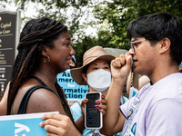 Nahla Owens, a rising junior at Harvard, and Kashish Bastola, a rising sophomore, also at Harvard, share a hug in solidarity as the protest...