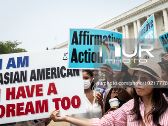 People protest (blue signs) and celebrate (white sign) the US Supreme Court ruling that universities cannot consider race in admissions.  Th...