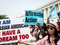 People protest (blue signs) and celebrate (white sign) the US Supreme Court ruling that universities cannot consider race in admissions.  Th...