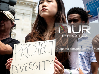 A woman protests the US Supreme Court ruling that universities cannot consider race in admissions.  The pair of cases brought by Students fo...