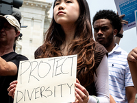 A woman protests the US Supreme Court ruling that universities cannot consider race in admissions.  The pair of cases brought by Students fo...