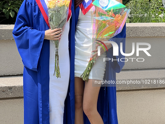 Youth dressed in caps and gowns celebrate their high school graduation in Toronto, Ontario, Canada, on June 29, 2023. (