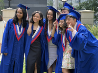 Youth dressed in caps and gowns celebrate their high school graduation in Toronto, Ontario, Canada, on June 29, 2023. (