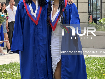 Youth dressed in caps and gowns celebrate their high school graduation in Toronto, Ontario, Canada, on June 29, 2023. (