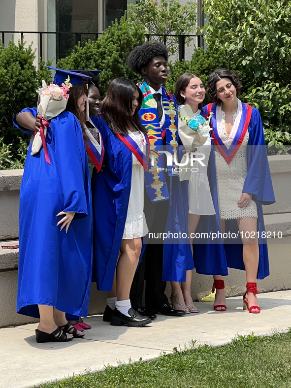 Youth dressed in caps and gowns celebrate their high school graduation in Toronto, Ontario, Canada, on June 29, 2023. 