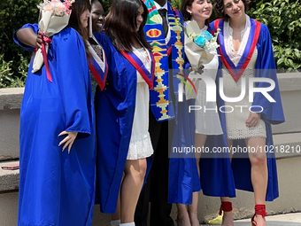 Youth dressed in caps and gowns celebrate their high school graduation in Toronto, Ontario, Canada, on June 29, 2023. (