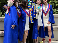 Youth dressed in caps and gowns celebrate their high school graduation in Toronto, Ontario, Canada, on June 29, 2023. (