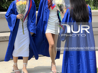 Youth dressed in caps and gowns celebrate their high school graduation in Toronto, Ontario, Canada, on June 29, 2023. (