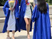 Youth dressed in caps and gowns celebrate their high school graduation in Toronto, Ontario, Canada, on June 29, 2023. (