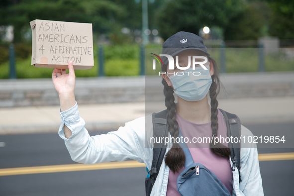 A demonstrator holds a sign outside of the Supreme Court in Washington, D.C. on June 30, 2023 following the Supreme Court's ruling striking...