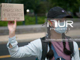 A demonstrator holds a sign outside of the Supreme Court in Washington, D.C. on June 30, 2023 following the Supreme Court's ruling striking...