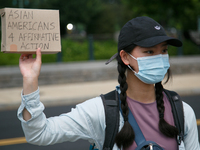 A demonstrator holds a sign outside of the Supreme Court in Washington, D.C. on June 30, 2023 following the Supreme Court's ruling striking...