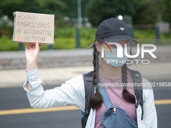 A demonstrator holds a sign outside of the Supreme Court in Washington, D.C. on June 30, 2023 following the Supreme Court's ruling striking...