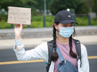 A demonstrator holds a sign outside of the Supreme Court in Washington, D.C. on June 30, 2023 following the Supreme Court's ruling striking...