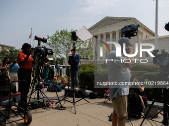 Members of the media gather outside of the Supreme Court in Washington, D.C. on June 30, 2023 following the Supreme Court's ruling that Pres...