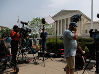 Members of the media gather outside of the Supreme Court in Washington, D.C. on June 30, 2023 following the Supreme Court's ruling that Pres...