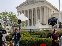 Members of the media gather outside of the Supreme Court in Washington, D.C. on June 30, 2023 following the Supreme Court's ruling that Pres...