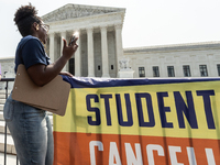 Satra Tayloir's phone catches the sun as she celebrates at the Supreme Court after it rules thta the plaintiff does not have standing to cha...