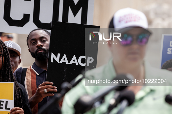 Jeremiah Baldwin of Austin, TX, holds an NAACP sign during a protest of the Supreme Court's ruling against President Joe Biden’s student-deb...