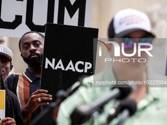 Jeremiah Baldwin of Austin, TX, holds an NAACP sign during a protest of the Supreme Court's ruling against President Joe Biden’s student-deb...