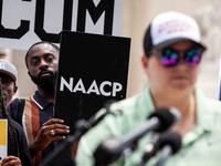 Jeremiah Baldwin of Austin, TX, holds an NAACP sign during a protest of the Supreme Court's ruling against President Joe Biden’s student-deb...