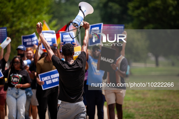 Derrick Lewis of the NAACP leads a march protesting the Supreme Court's ruling against President Joe Biden’s student-debt relief program.  T...