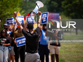 Derrick Lewis of the NAACP leads a march protesting the Supreme Court's ruling against President Joe Biden’s student-debt relief program.  T...