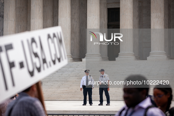 Supreme Court Police keep an eye on the crowd protesting Court's ruling against President Joe Biden’s student-debt relief program.  The opin...