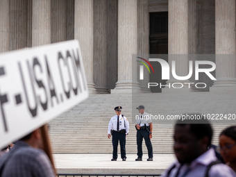 Supreme Court Police keep an eye on the crowd protesting Court's ruling against President Joe Biden’s student-debt relief program.  The opin...