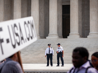 Supreme Court Police keep an eye on the crowd protesting Court's ruling against President Joe Biden’s student-debt relief program.  The opin...