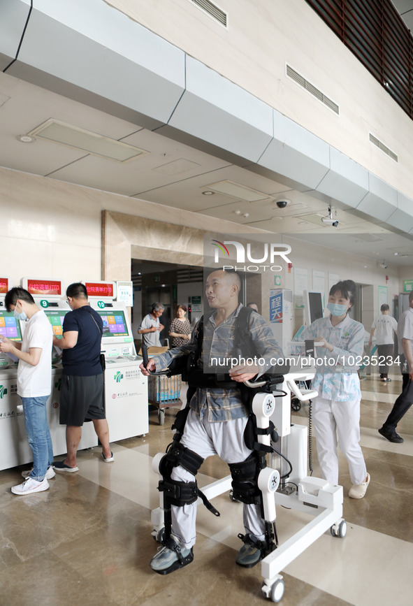  Medical staff use a lower limb rehabilitation robot to help patients recover in Chongqing, China, July 4, 2023. 