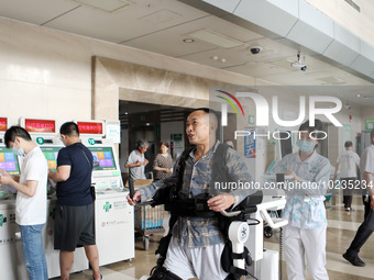  Medical staff use a lower limb rehabilitation robot to help patients recover in Chongqing, China, July 4, 2023. (