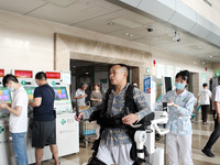  Medical staff use a lower limb rehabilitation robot to help patients recover in Chongqing, China, July 4, 2023. (