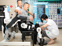 

Medical staff are fastening a patient to a lower limb rehabilitation robot in Chongqing, China, on July 4, 2023. (