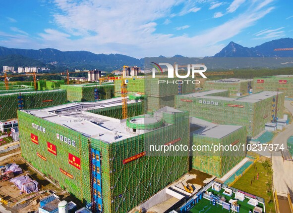 

An aerial photo shows the construction of the new schools of Yuexi Middle School in Anqing City, Anhui Province, China on July 5, 2023. 