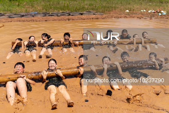 

Children are training during the ''Tactical Quagmire'' program at a military summer camp in Hefei, Anhui Province, China on July 5, 2023. 