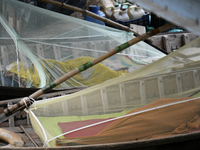 Boatmans sleep under a mosquito nets on their boats to protect them from dengue at the bank of the Buriganga River in Dhaka, Bangladesh, on...