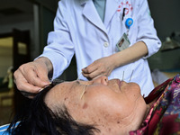 

A medical worker is giving acupuncture treatment to a citizen in the rehabilitation Department of Traditional Chinese Medicine at Qingzhou...