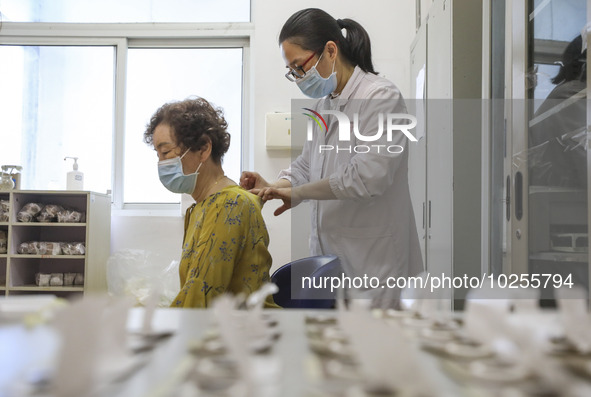 

A medical worker is applying traditional Chinese medicine Sanfu stickers to a citizen in Huai'an City, Jiangsu Province, China, on July 11...