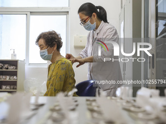 

A medical worker is applying traditional Chinese medicine Sanfu stickers to a citizen in Huai'an City, Jiangsu Province, China, on July 11...