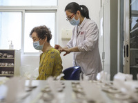 

A medical worker is applying traditional Chinese medicine Sanfu stickers to a citizen in Huai'an City, Jiangsu Province, China, on July 11...