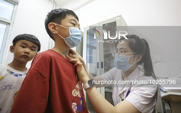 

A medical worker is applying traditional Chinese medicine Sanfu stickers to a citizen in Huai'an City, Jiangsu Province, China, on July 11...