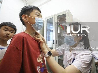 

A medical worker is applying traditional Chinese medicine Sanfu stickers to a citizen in Huai'an City, Jiangsu Province, China, on July 11...