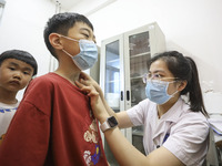 

A medical worker is applying traditional Chinese medicine Sanfu stickers to a citizen in Huai'an City, Jiangsu Province, China, on July 11...