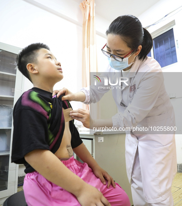 

A medical worker is applying traditional Chinese medicine Sanfu stickers to a citizen in Huai'an City, Jiangsu Province, China, on July 11...