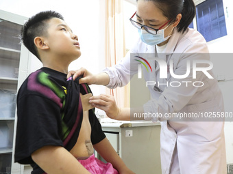 

A medical worker is applying traditional Chinese medicine Sanfu stickers to a citizen in Huai'an City, Jiangsu Province, China, on July 11...